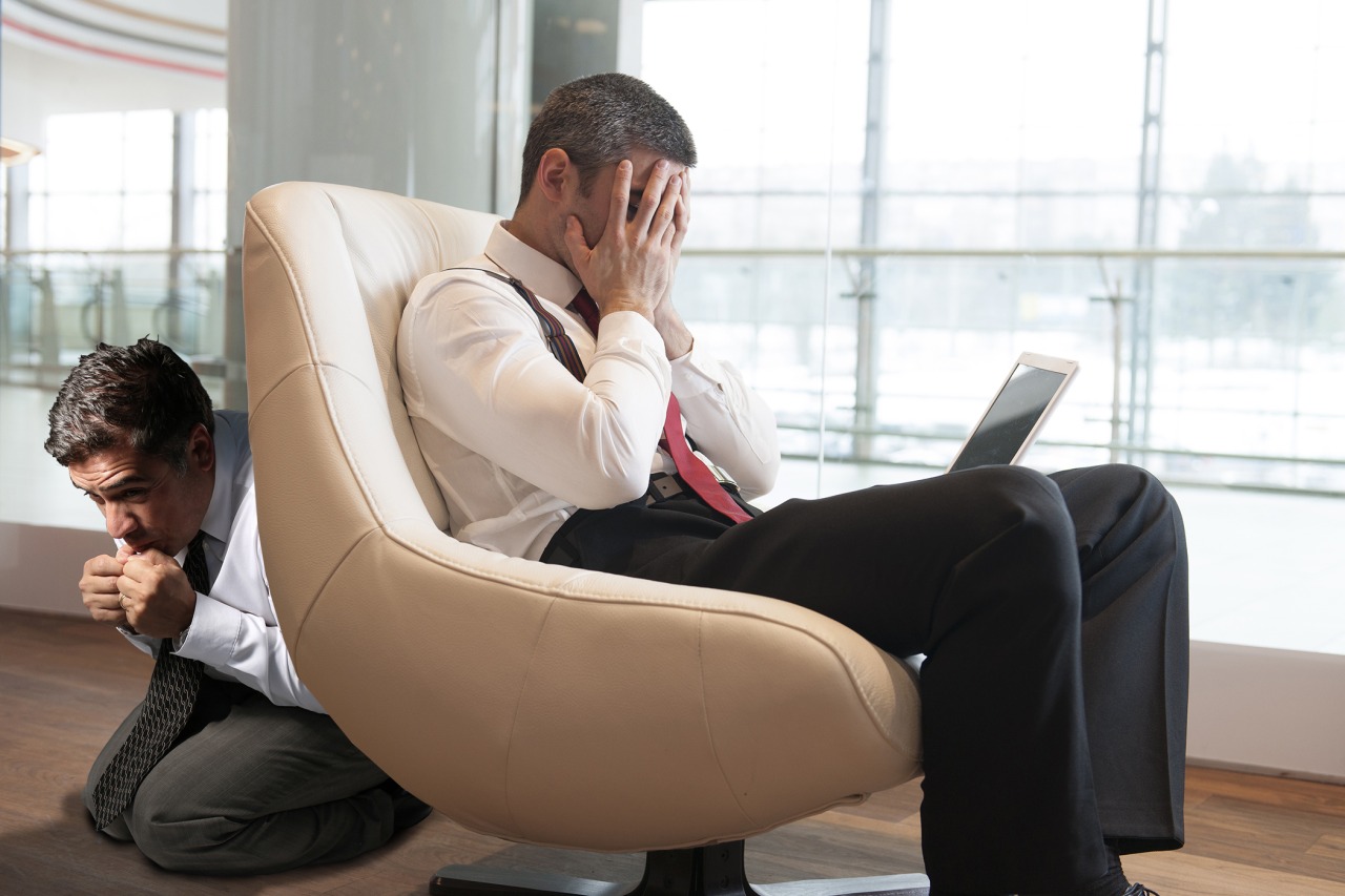 The Stock Photobomber Stressed out businessman covers face with hands